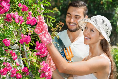 Landscape gardener revitalizing a garden with jet wash equipment